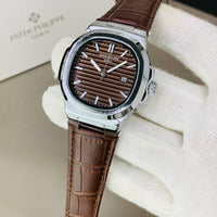 PATEK PHILIPPE GENEVE FAMOUS NATULIS MODEL WITH LEATHER STREP BRASS CASE WITH PATEK MONOGRAM LOCK